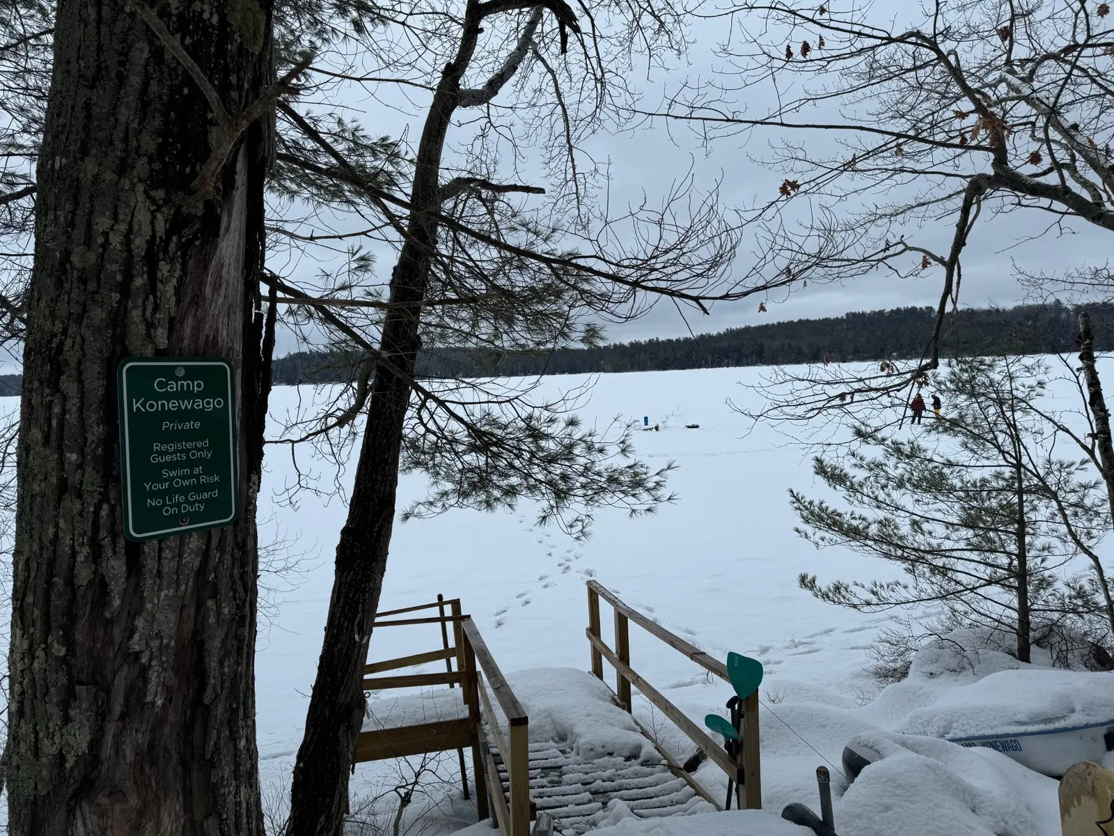 Snow-covered steps leading to frozen Keoka Lake